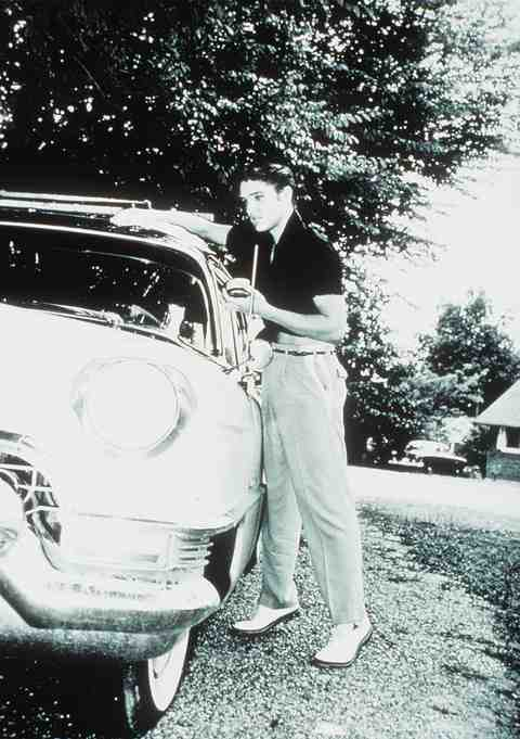 Two bw pictures from 1955 of Elvis with this car when it had a black 